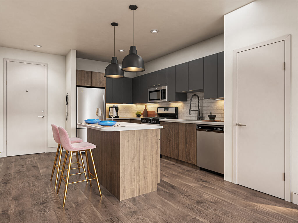 A sleek, modern kitchen with dark cabinets and a kitchen island at the V2 Apartments in Chelsea, Massachusetts.